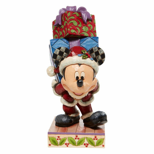 Mickey Mouse figurine wearing a Christmas hat with presents on a white background