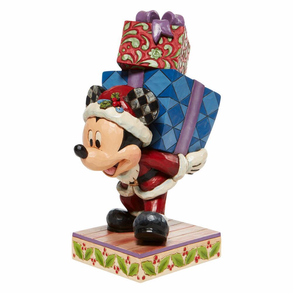 Mickey Mouse figurine with a colorful gift box on a white background