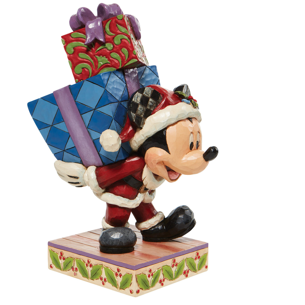 A Disney Jim Shore collectible figurine of Mickey Mouse dressed as Santa Claus, carrying a large stack of wrapped presents on his back, set against a plain white background.