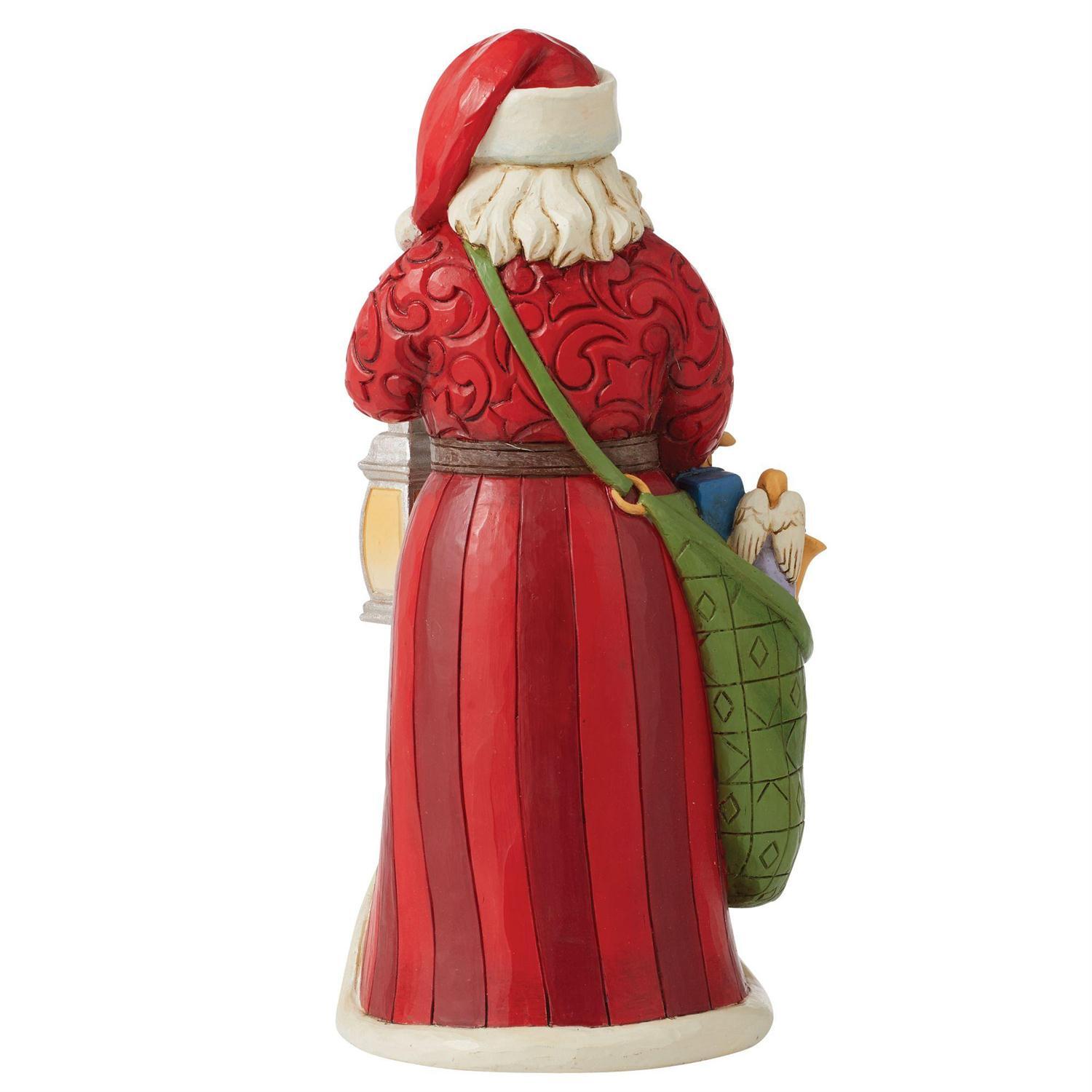 Santa Claus figurine with a green sack on a white background