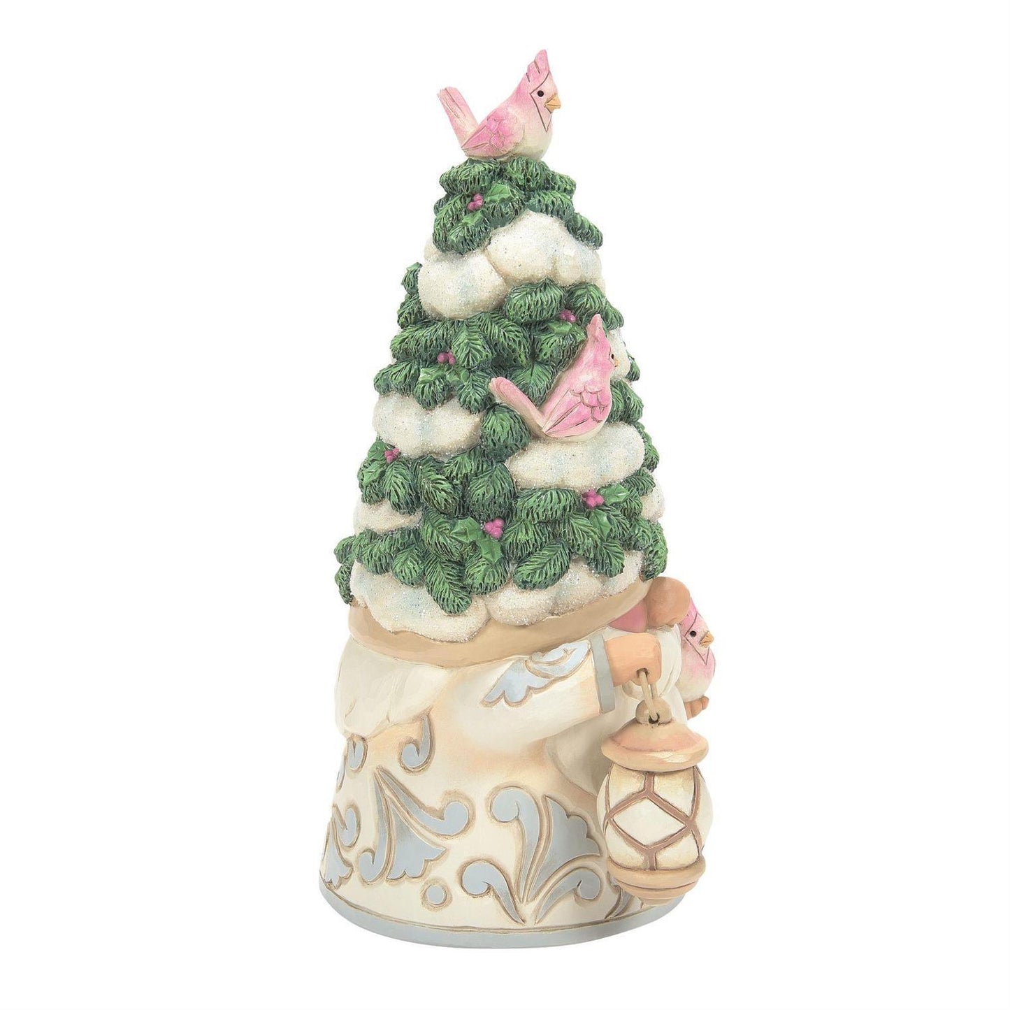 A decorative Christmas figurine featuring a snowy evergreen tree with pink birds perched on the branches, set on a cream-colored base with blue scrollwork and a hanging lantern.