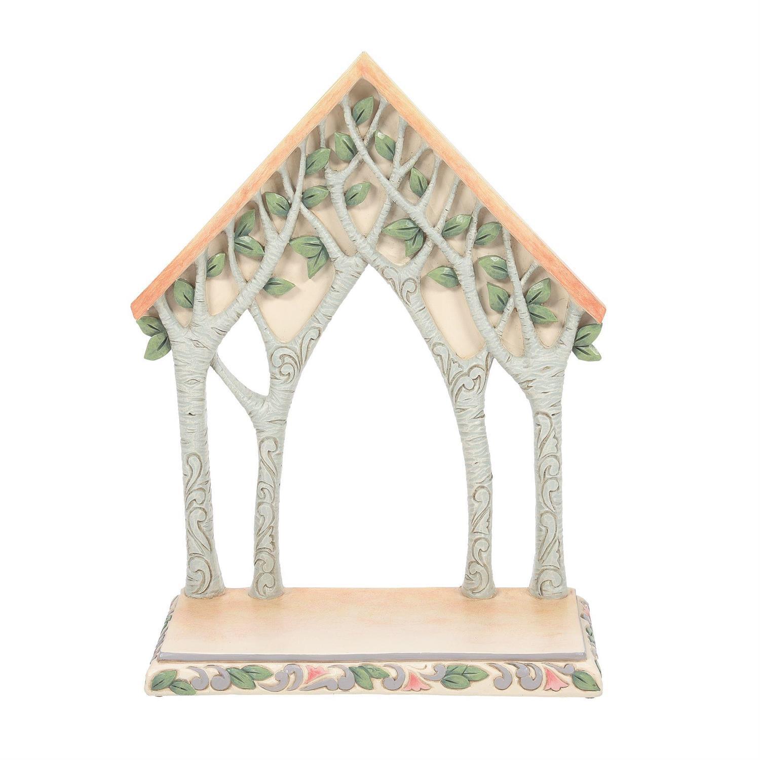 A decorative treehouse-style figurine or shelf piece with three arched tree trunks, a peach-tan roof, and green leaves, shown on a plain white background.