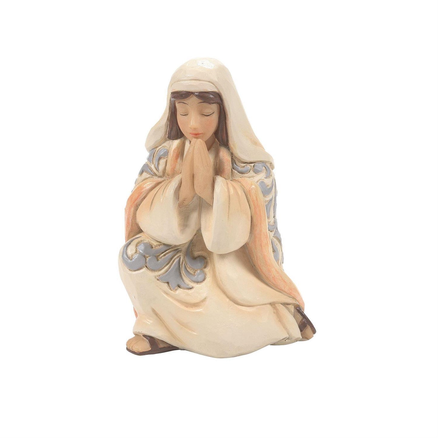 A praying figurine of the Virgin Mary in cream-colored robes with light blue and peach accents, set against a plain white background.