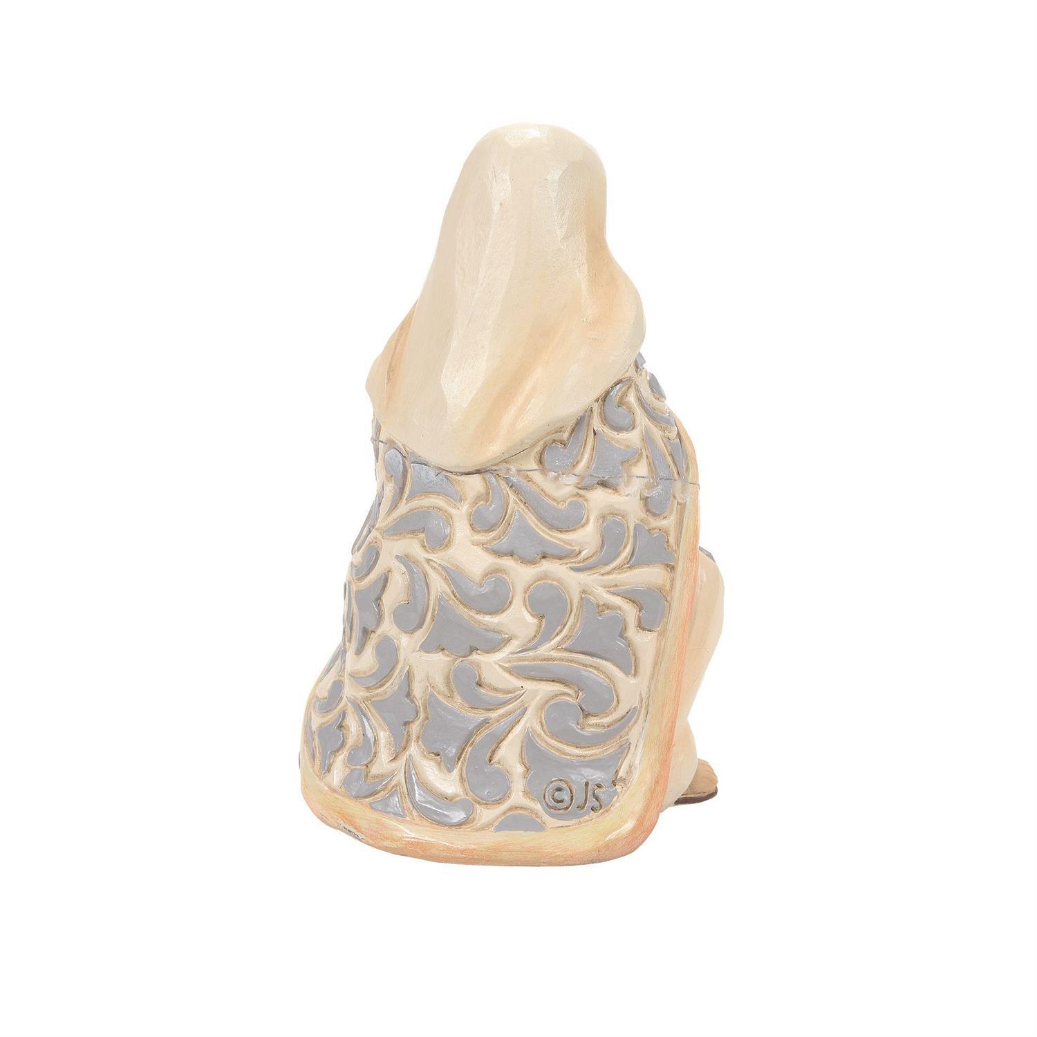 A ceramic figurine of a seated figure viewed from the back, featuring a cream-colored top and a patterned back with gray and cream swirls, on a plain white background.