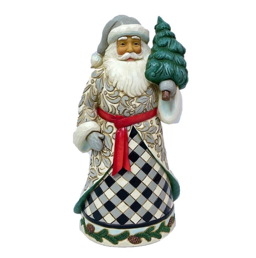 Decorative Santa Claus figurine holding a tree on a white background