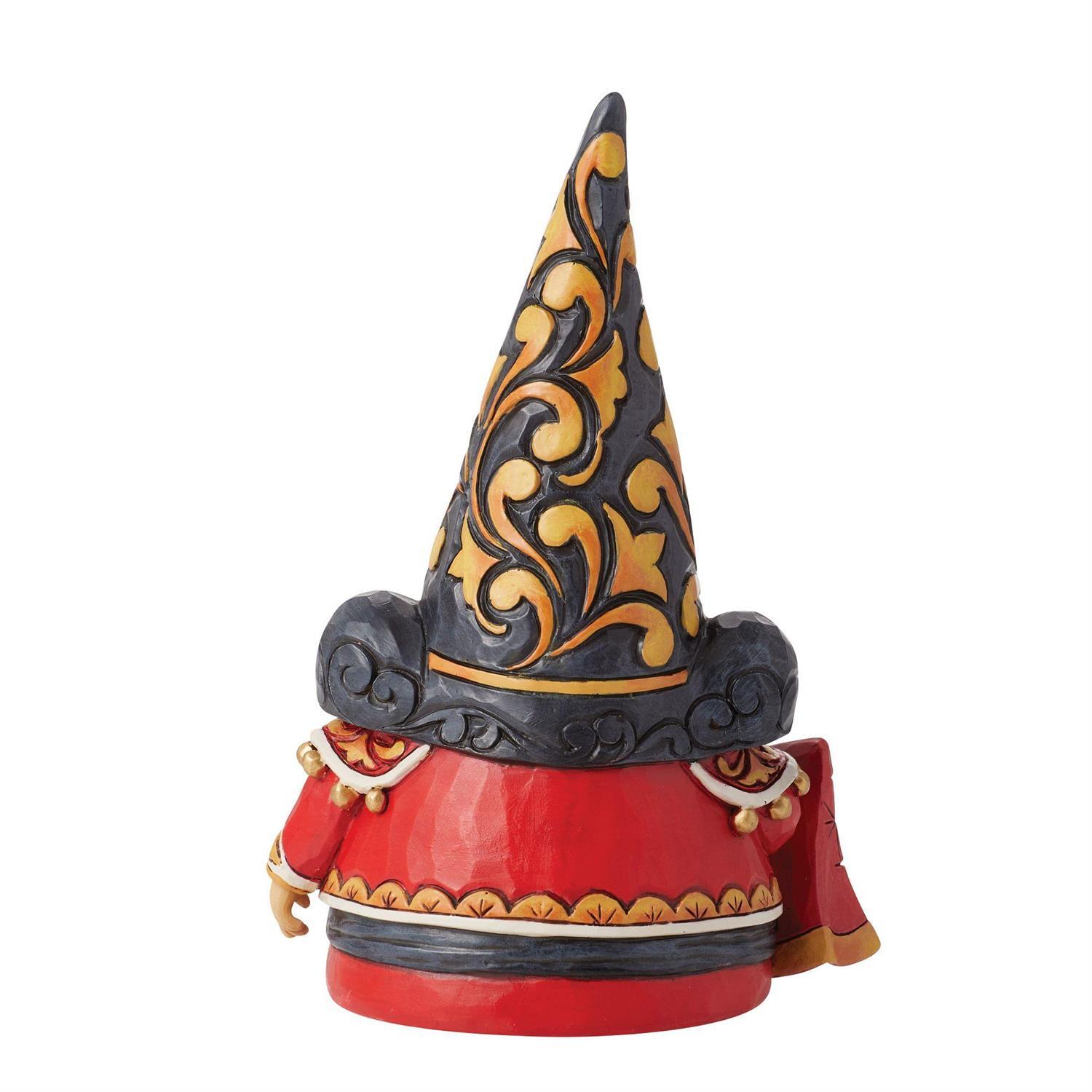 A decorative figurine of a character wearing a tall pointed black hat with gold scrollwork and a red outfit with gold trim, shown on a plain white background.