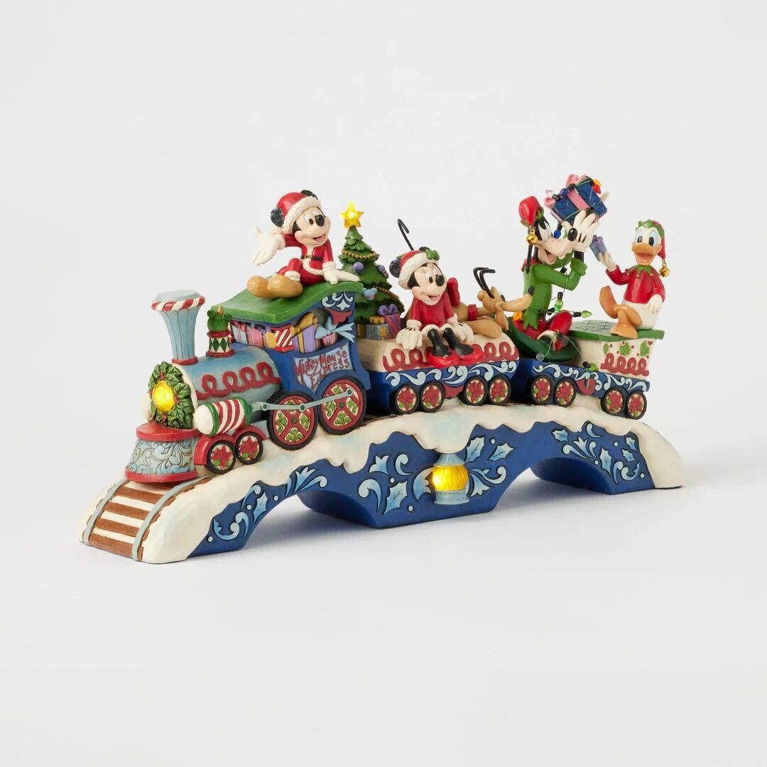 Colorful train figurine with animated characters on a white background