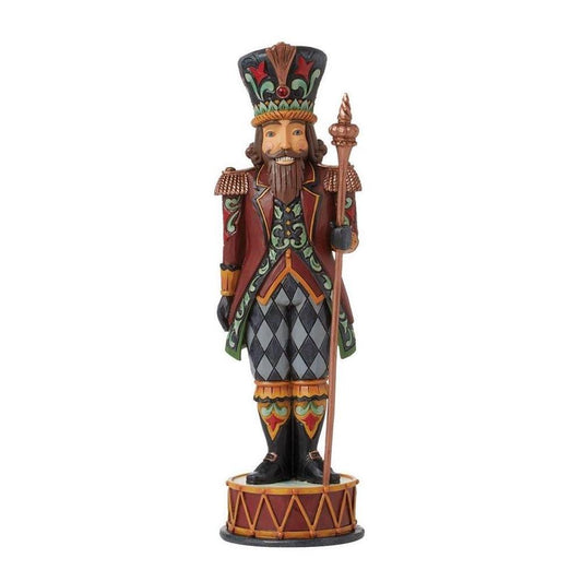 Decorative figurine of a bearded man in a colorful outfit with a hat and staff on a white background