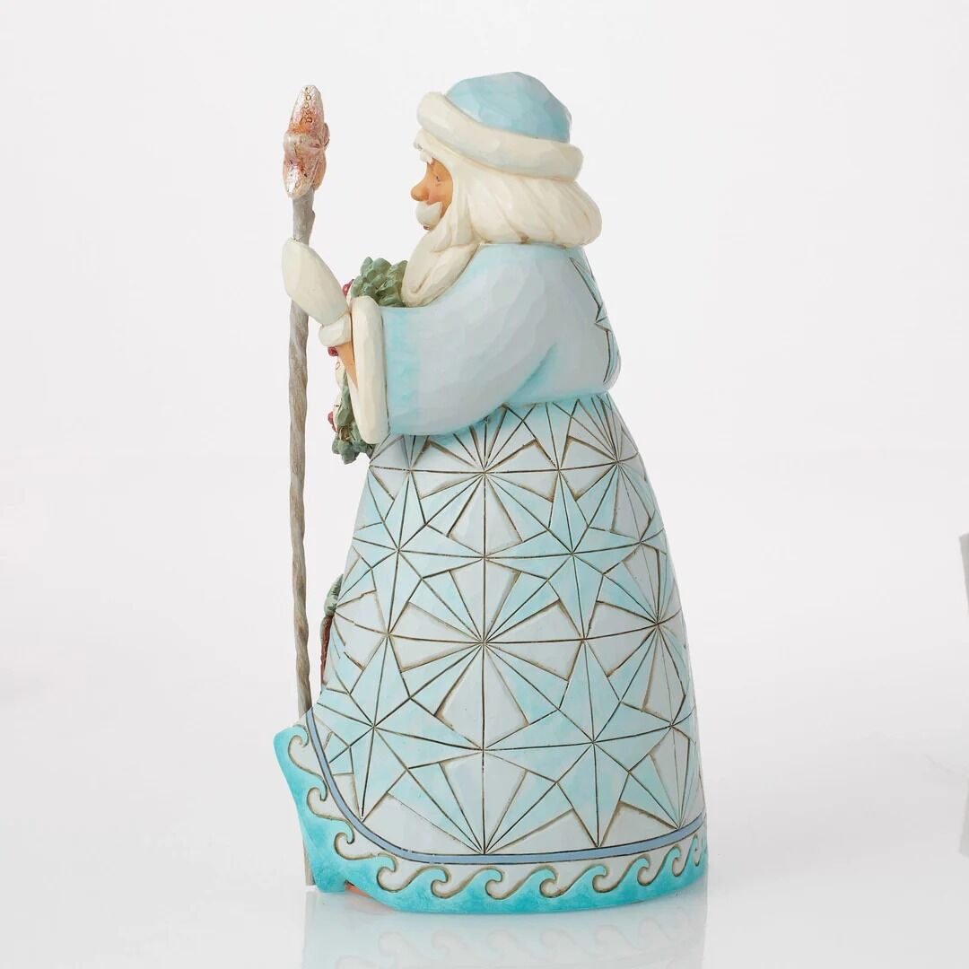 Decorative figurine of a character in a geometric-patterned outfit with a staff on a white background