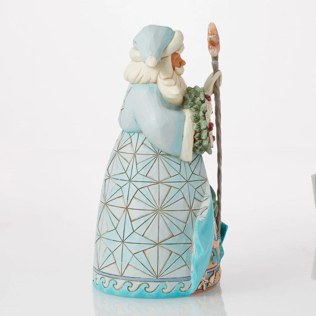 Decorative figurine of a Santa Claus holding a wreath on a white background