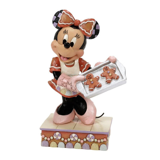 Minnie Mouse figurine with gingerbread cookies on a white background