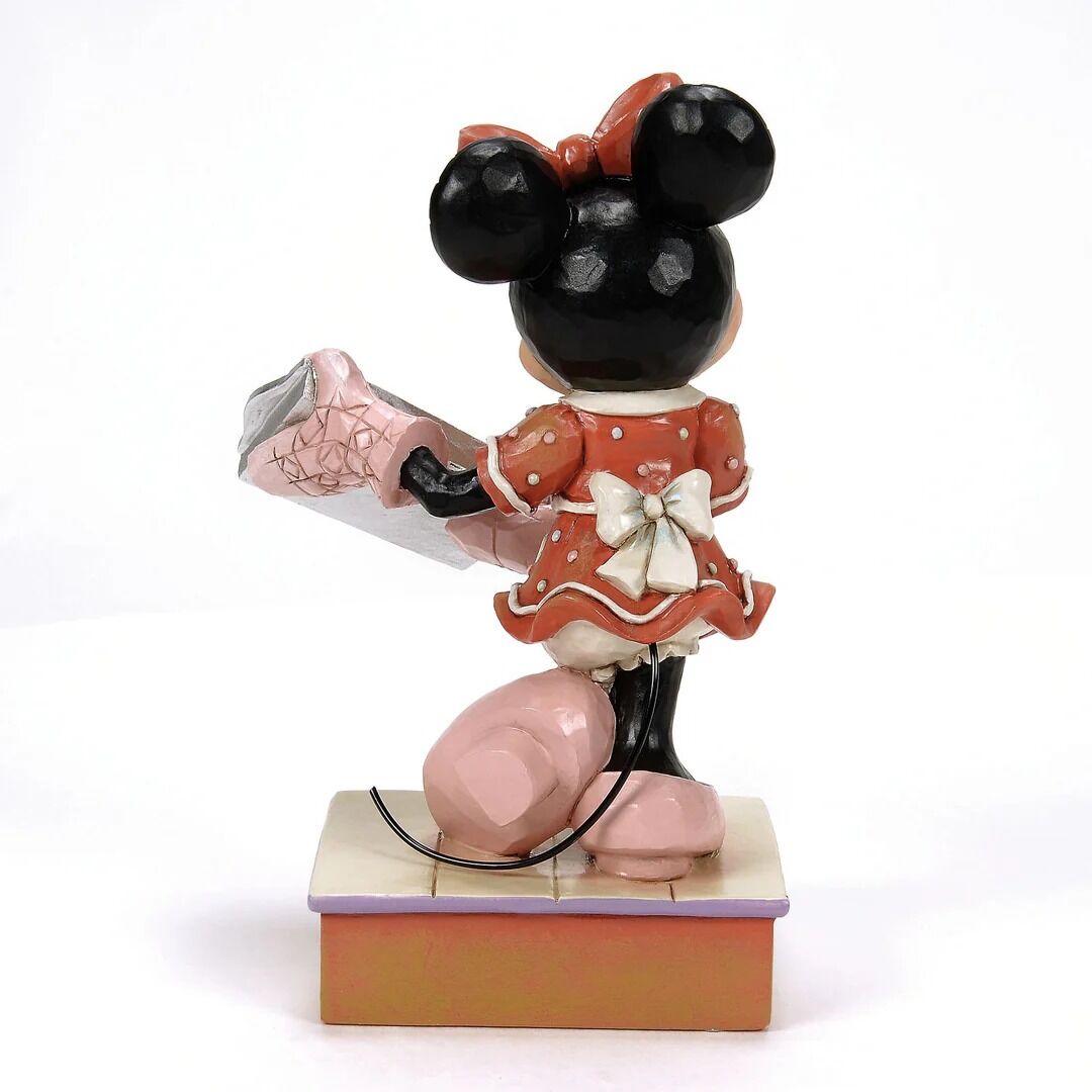 Figurine of a character in a red dress with a microphone on a white background