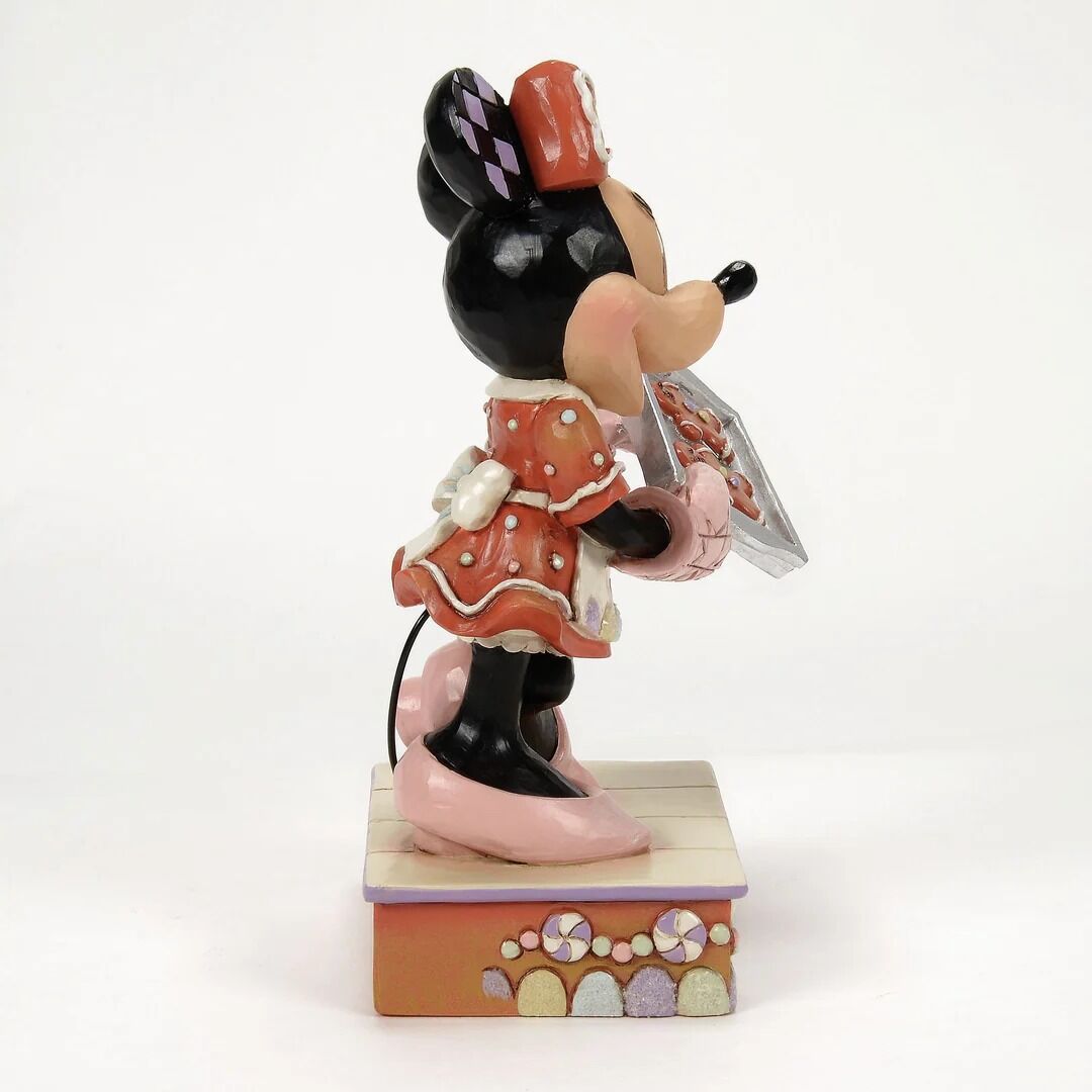 Decorative figurine of a character holding a card on a white background