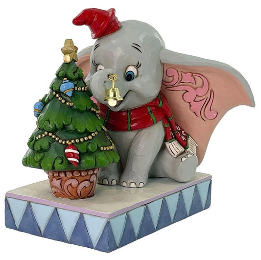Animated character figurine with a Christmas tree and bell on a white background