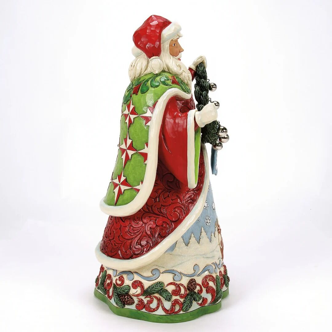 Colorful ceramic figurine of a character with a red hat and green cape on a white background