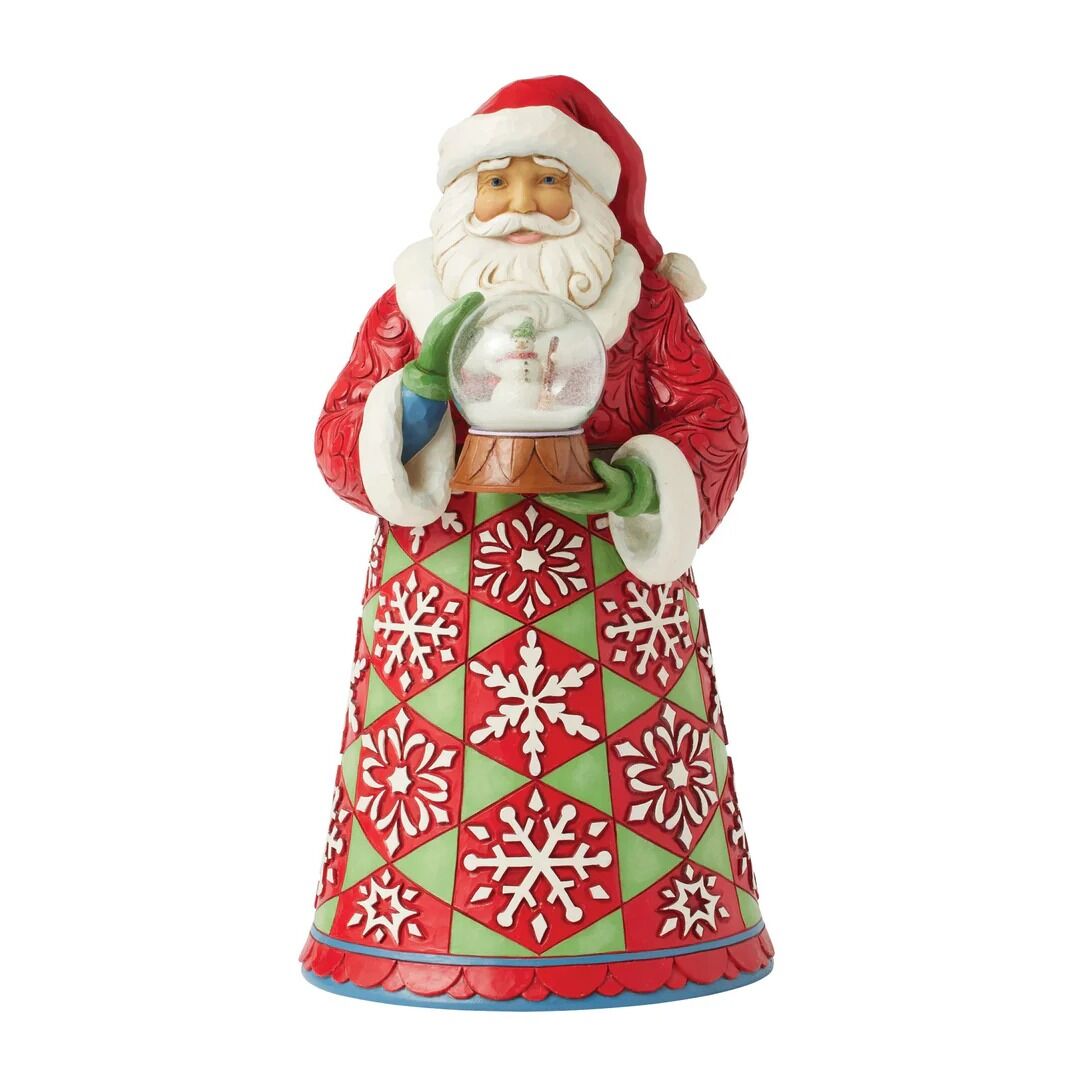 A Santa Claus figurine holding a clear snow globe, wearing a red and green patterned robe with white trim, photographed on a plain white background.