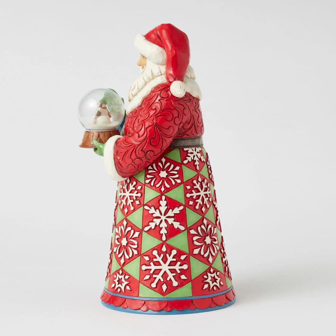 Decorative figurine of a Santa Claus holding a snow globe with a white background