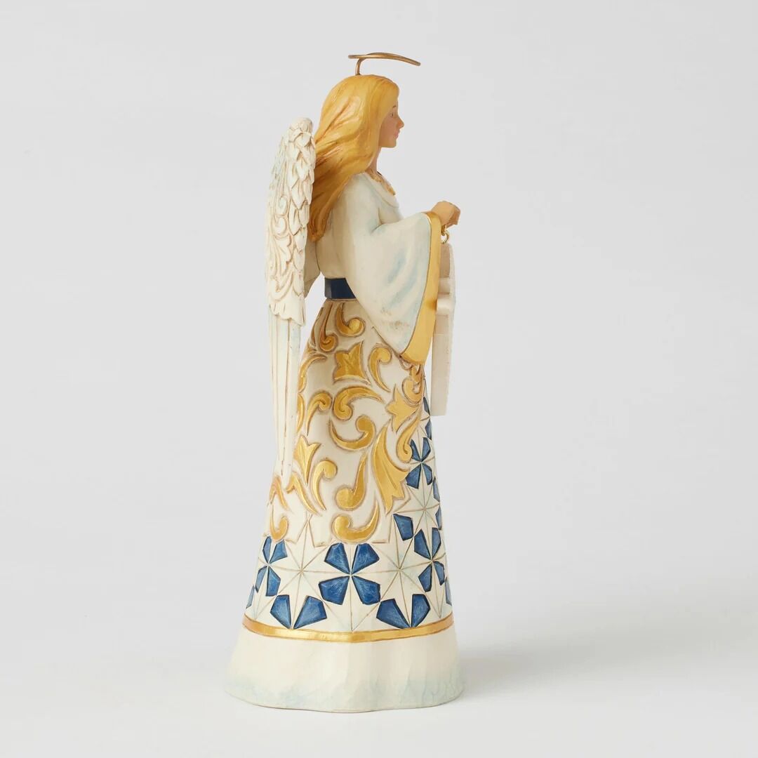 Decorative angel figurine with intricate designs on a white background