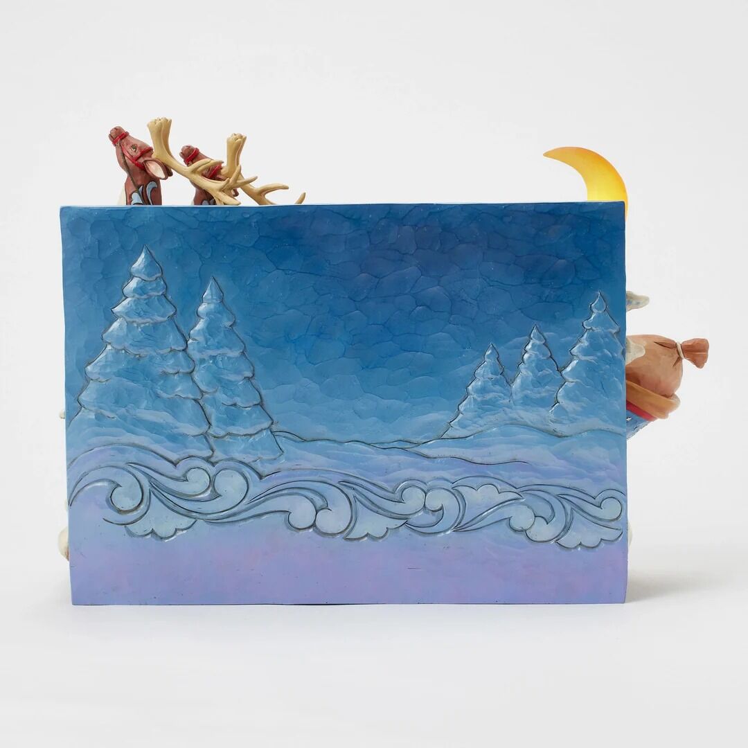Handmade card with a winter landscape design featuring trees and a moon.