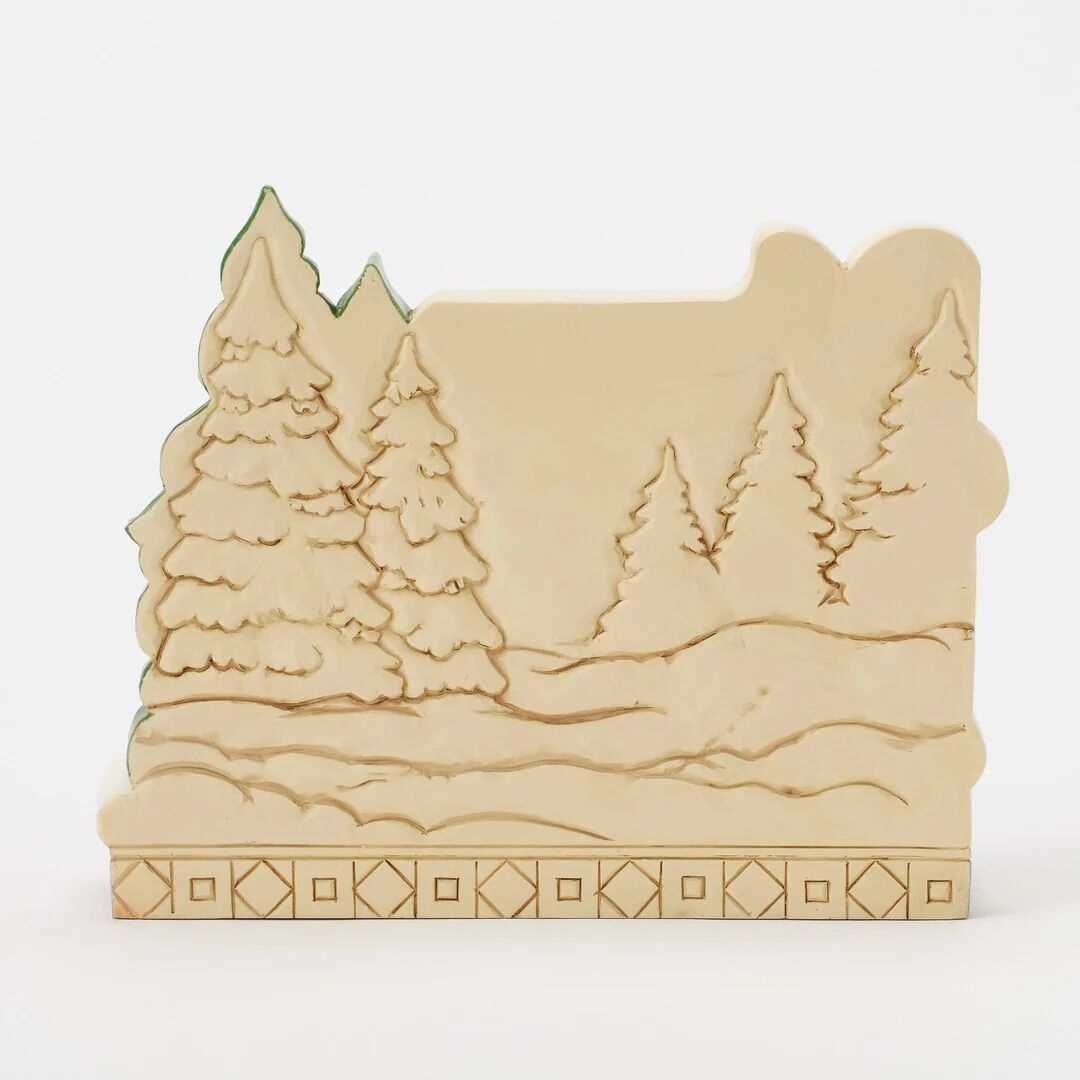 Wooden laser cutout with a forest design on a white background