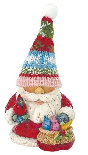 Decorative gnome figurine with a colorful hat and basket of items on a white background