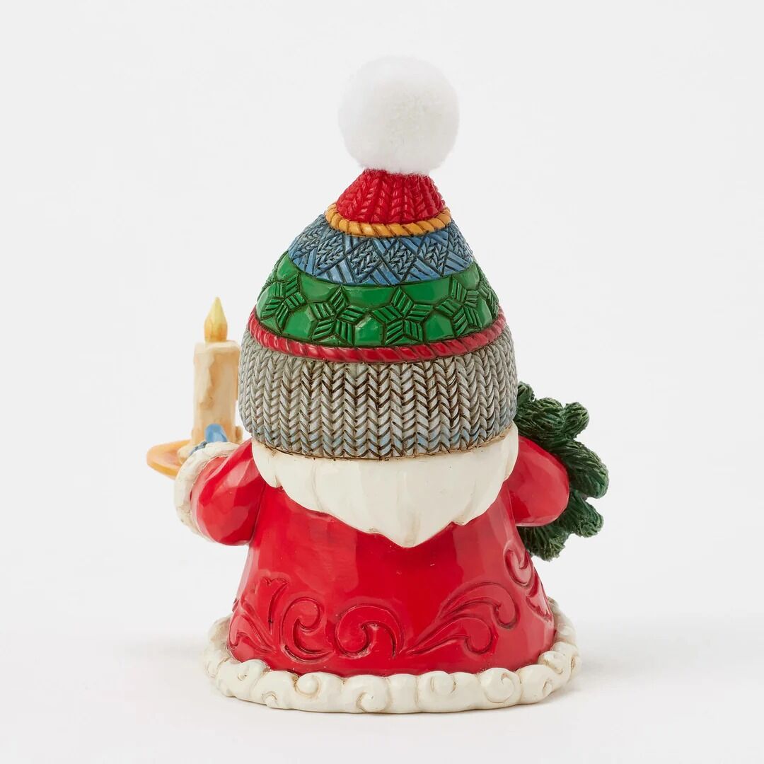 Decorative gnome figurine wearing a colorful knitted hat on a white background