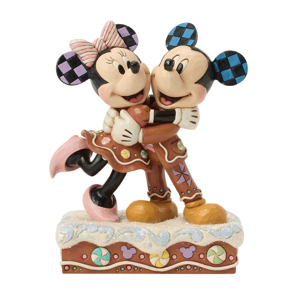 A Disney Mickey and Minnie Mouse figurine in a gingerbread-themed pose, standing on a decorated base against a plain white background.