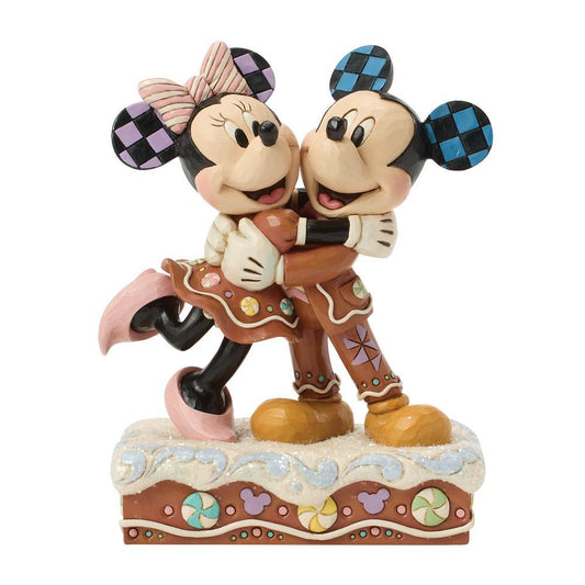 A Disney Mickey and Minnie Mouse figurine in a gingerbread-themed pose, standing on a decorated base against a plain white background.