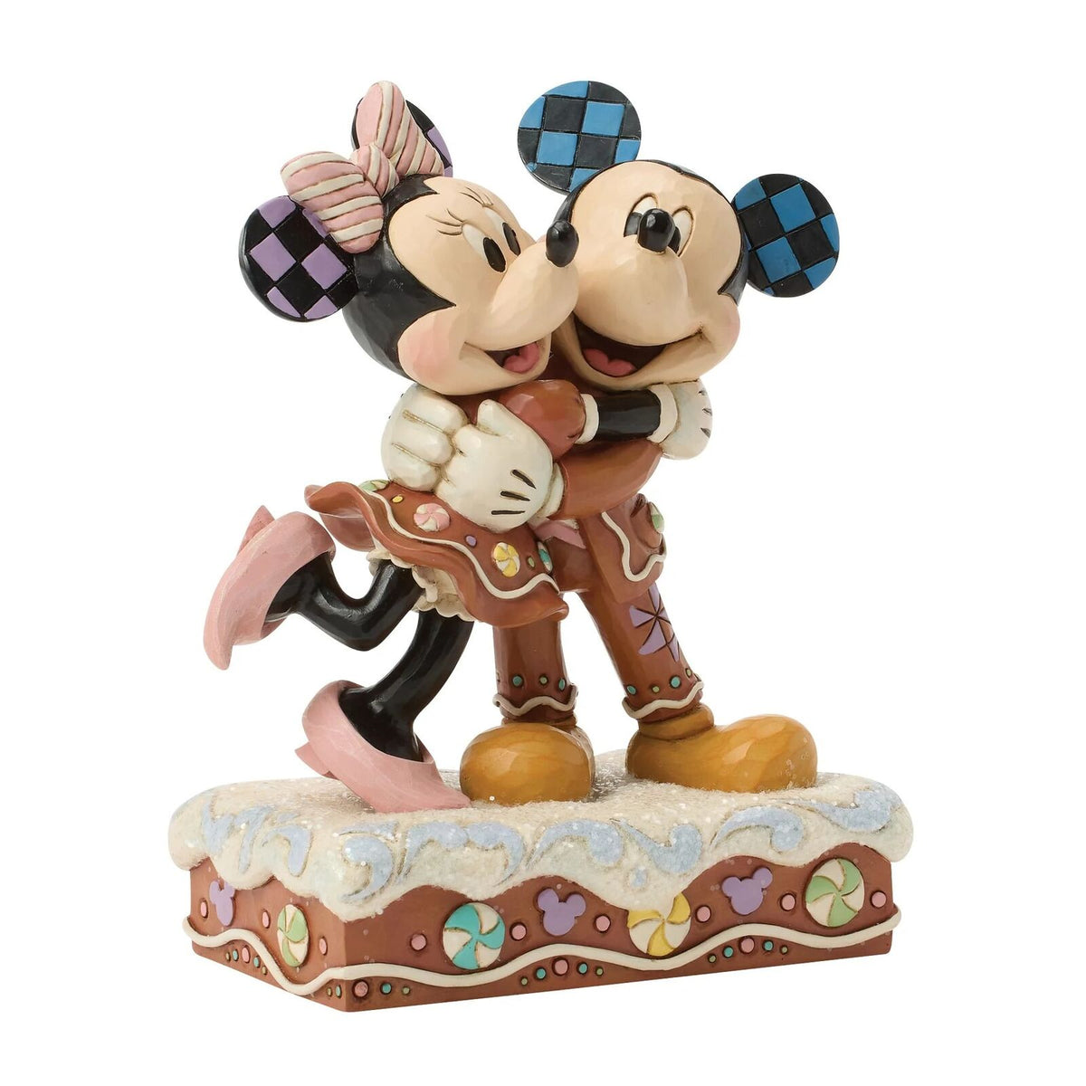 Statue of a couple in cowboy outfits on a decorative base with a white background