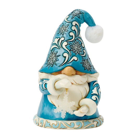 Decorative gnome figurine with blue hat and snowflake patterns on a white background
