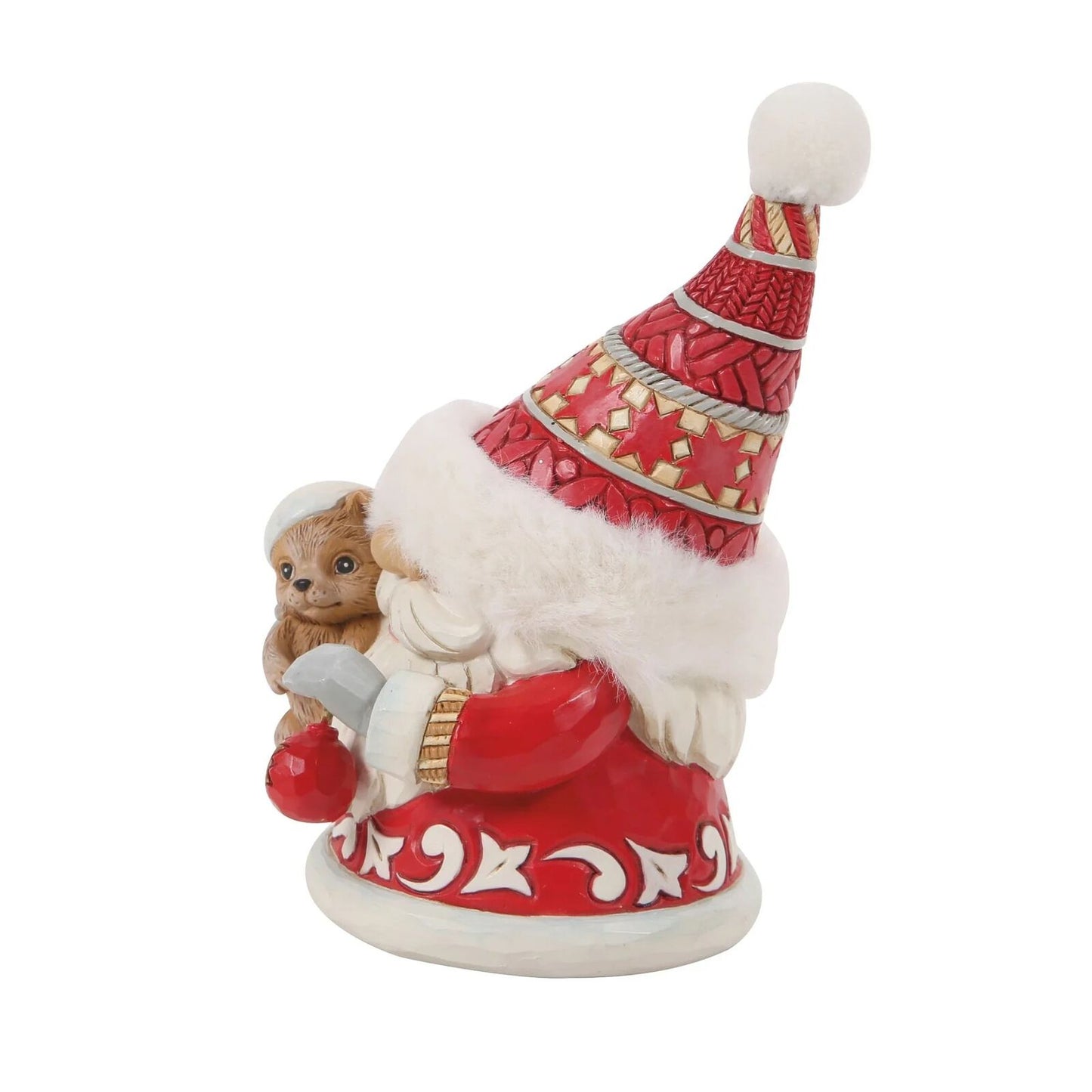 Decorative figure of a gnome in a red hat with a teddy bear, on a white background