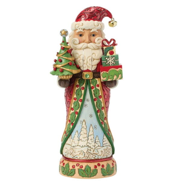 A hand-painted Christmas figurine of Santa Claus holding a decorated Christmas tree and a gift box, set against a plain white background.