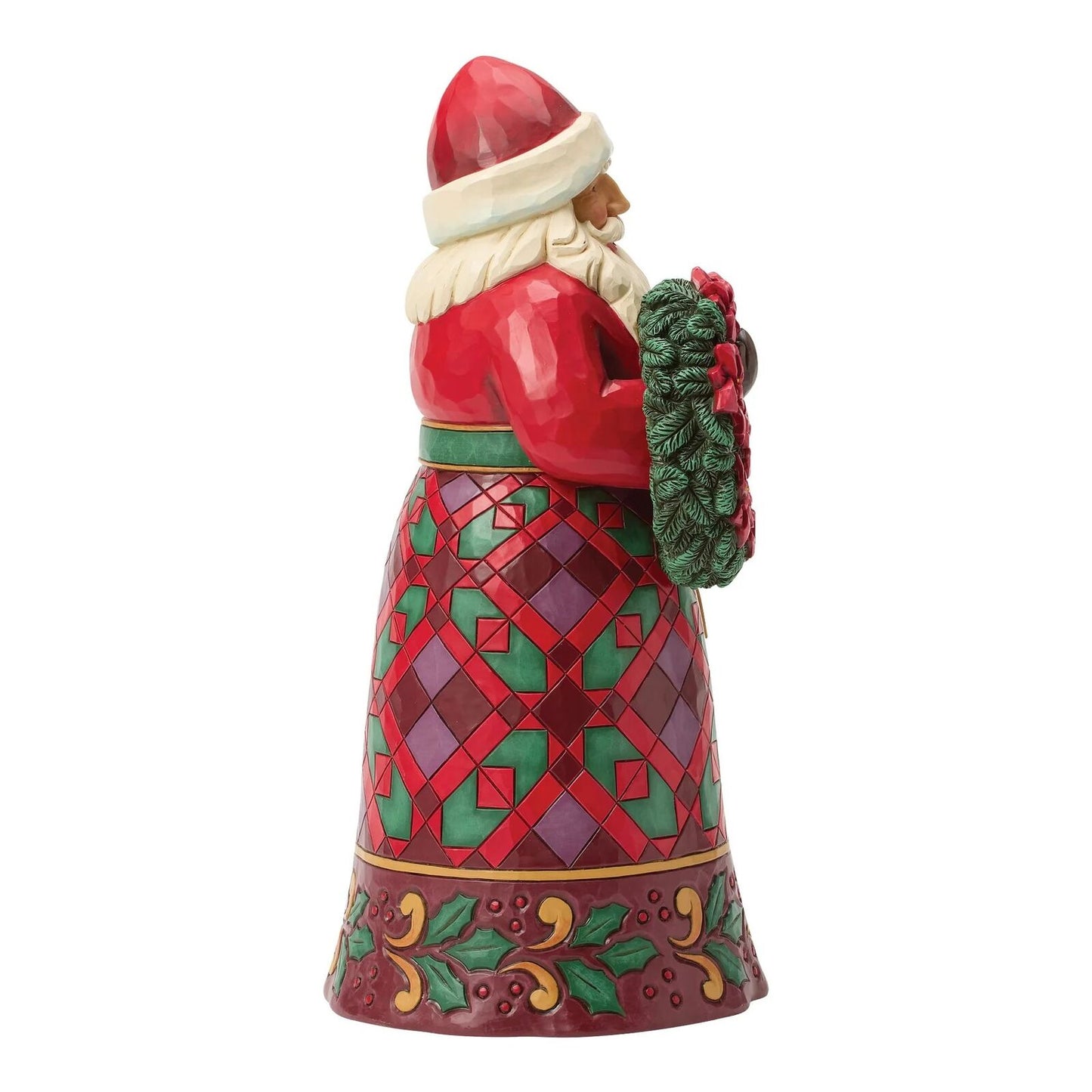 Decorative figurine of a Santa Claus holding a wreath on a white background