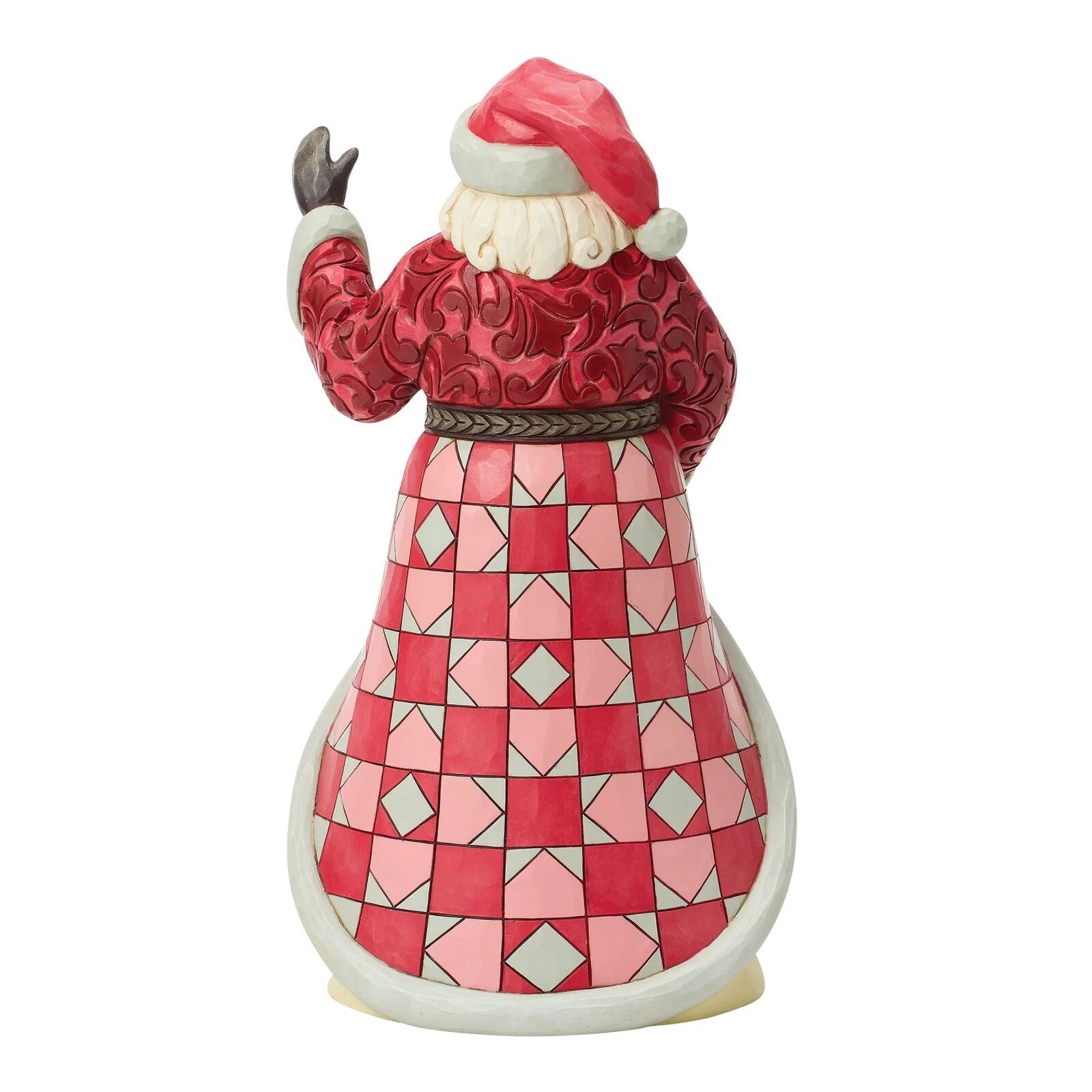 Decorative figurine of a character in a red and pink patterned outfit on a white background