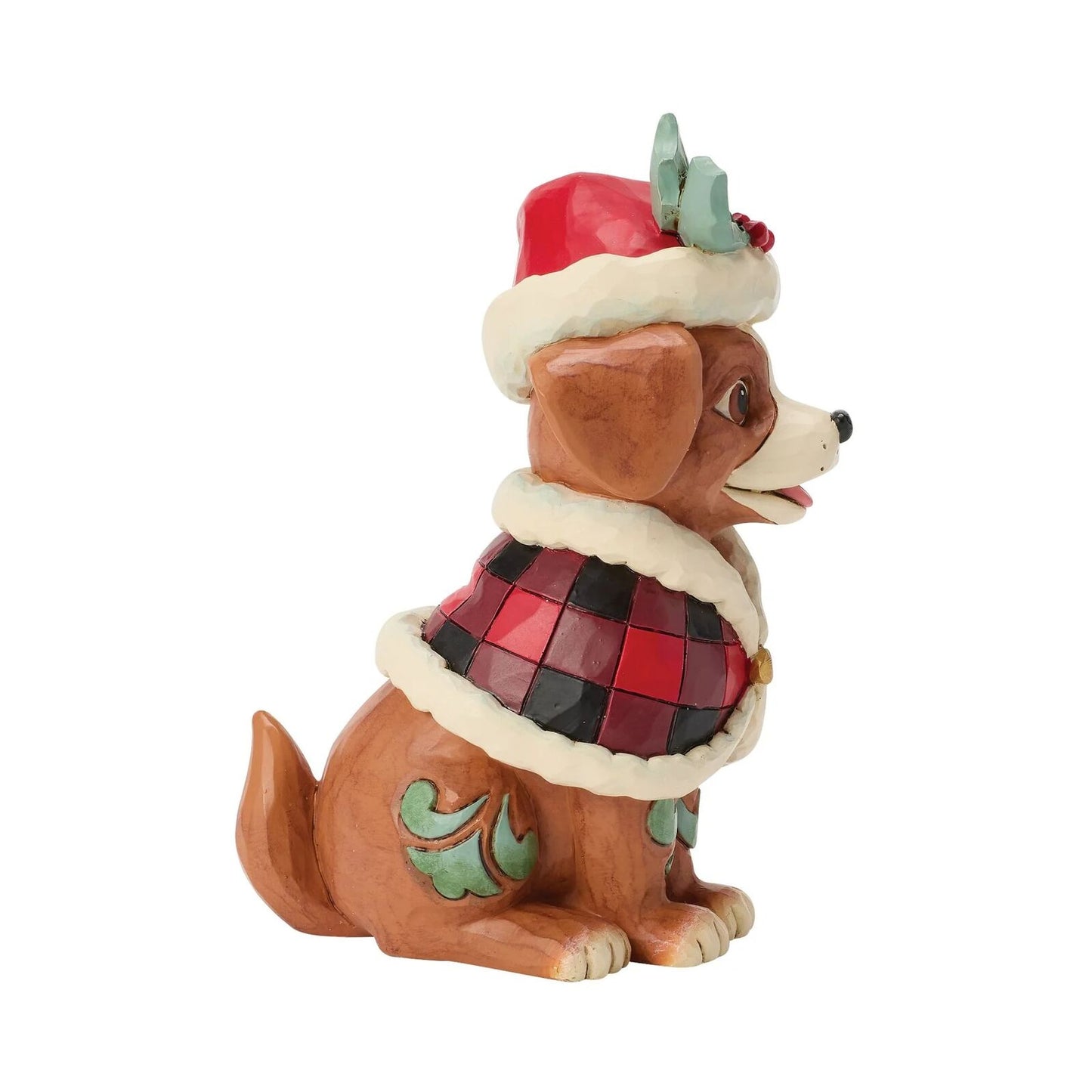Dog figurine wearing a Christmas hat and coat on a white background