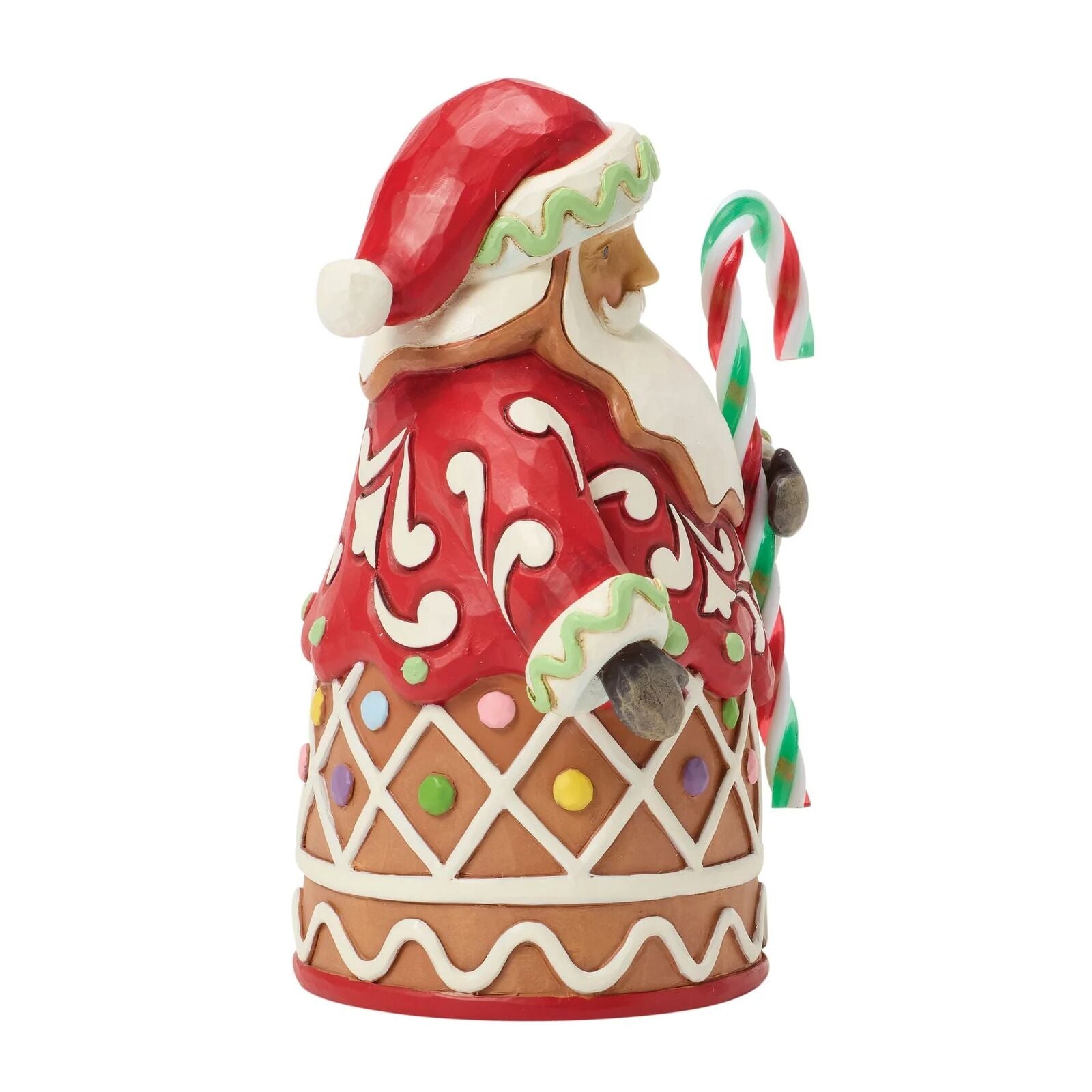 Decorative gingerbread man figurine with a candy cane on a white background