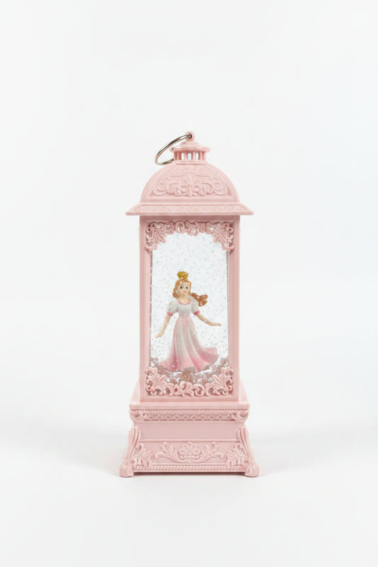 A pink decorative lantern-shaped ornament featuring a small princess figurine inside a clear front pane