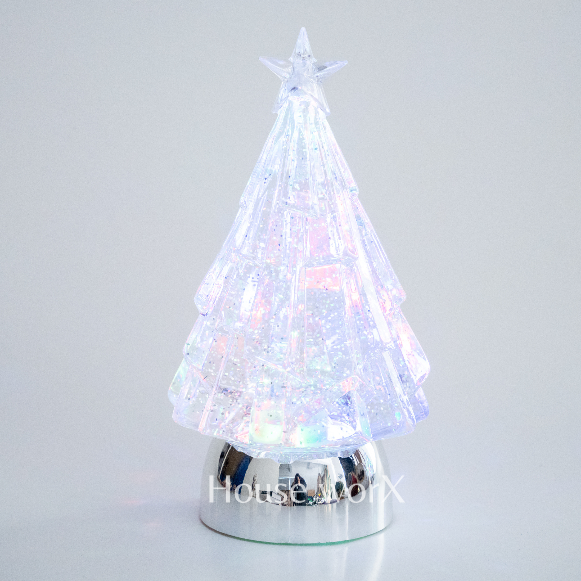 Colorful LED Christmas tree on a reflective base with a star on a gray snow globe background