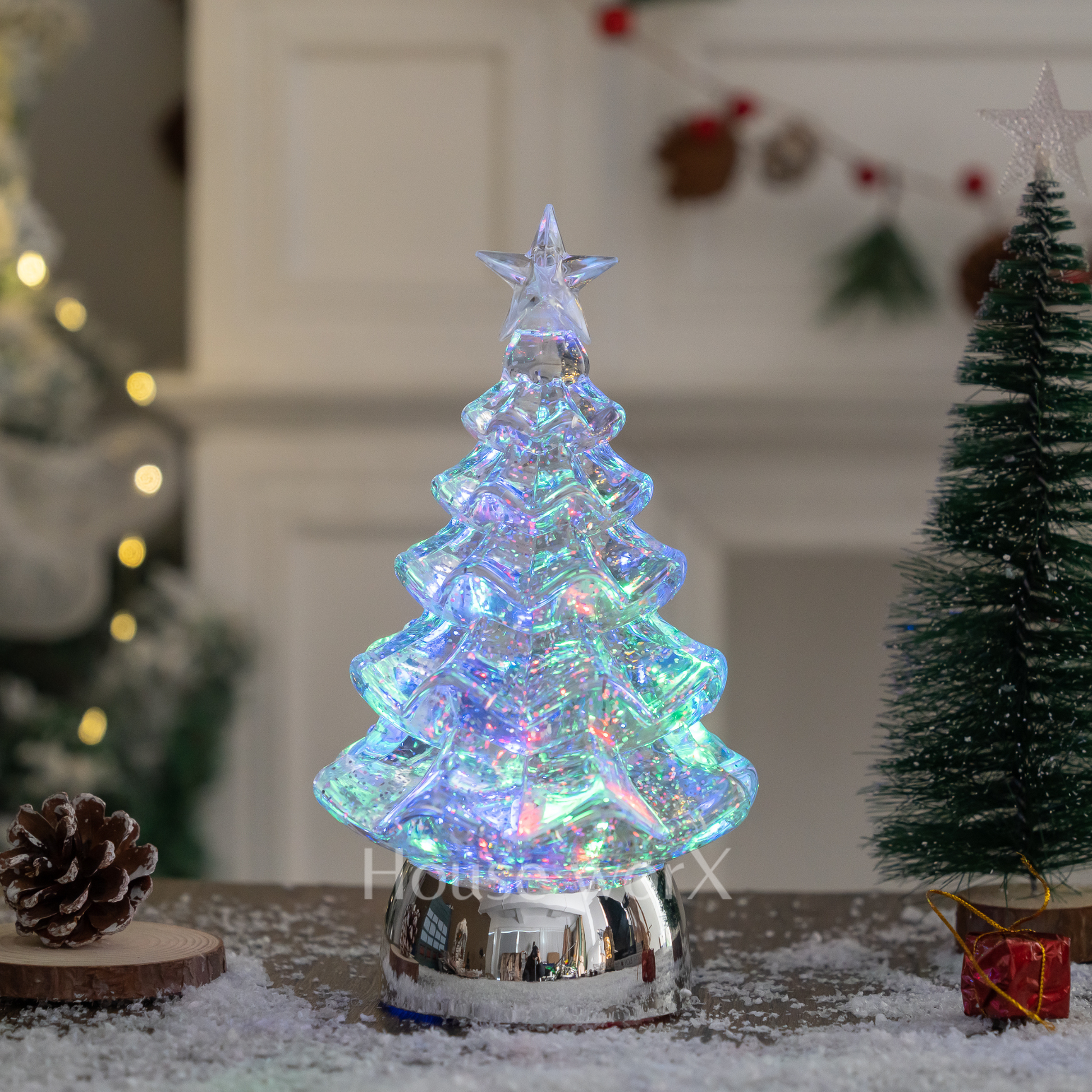 Iridescent Christmas tree decoration with a star on top, surrounded by festive decor. snow globe