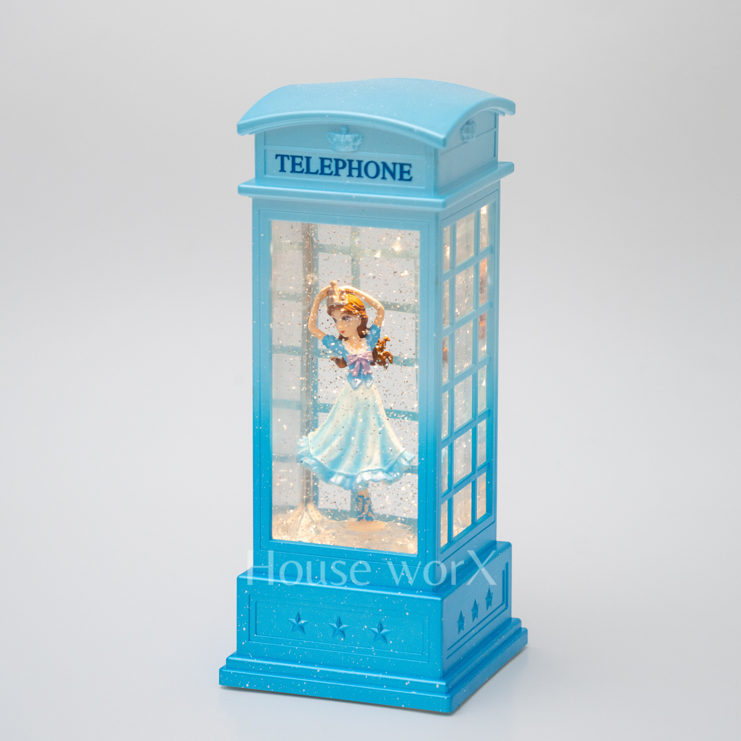 Blue telephone booth snow globe with a figurine inside on a white background
