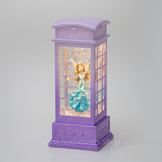 Decorative purple lamp with a figure inside on a gray background