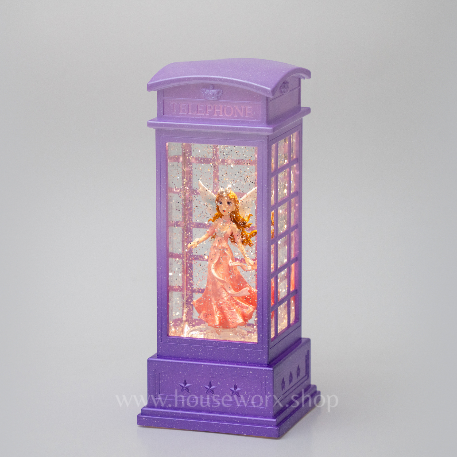 Purple telephone booth with a fairy in a pink dress on a gray background