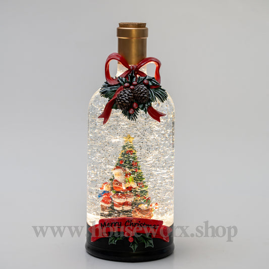Decorative bottle with a Christmas scene inside, featuring a tree and Santa Claus, on a gray background. christmas snow globe