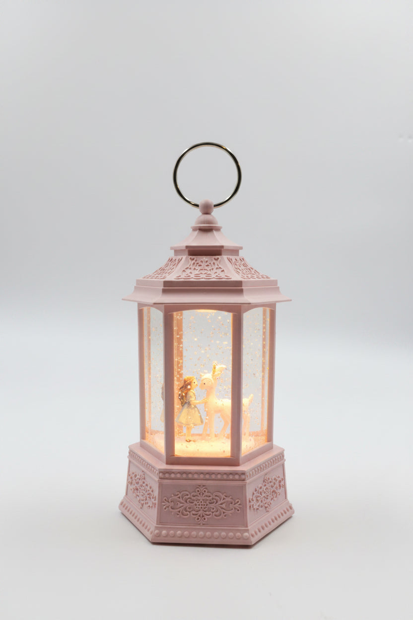 A pink decorative lantern with a hanging ring, featuring a warm glowing fairy light inside, set against a plain gray background.