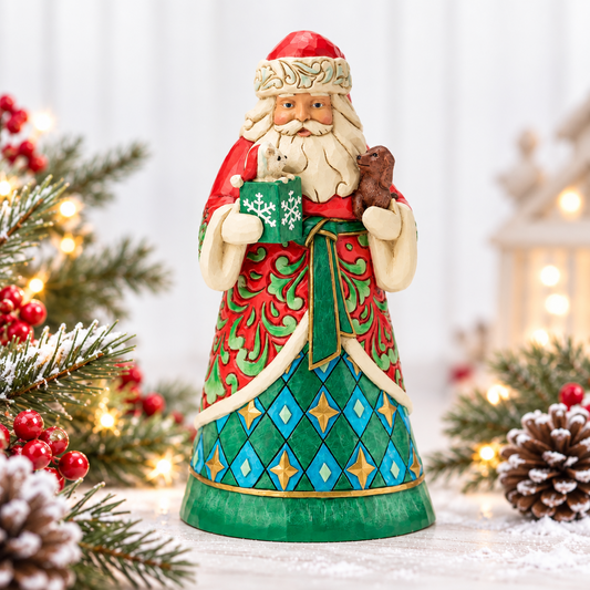 Jim Shore Heartwood Creek Santa Claus figurine holding a green snow globe with a white snowflake and a brown snowman, surrounded by holiday decorations including pine branches, pinecones, and warm string lights. Brand logos for Jim Shore and Christmas Snow Globes by House Worx are visible in the top corners.
