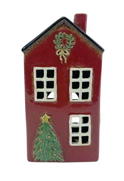 Decorative red house ornament with a wreath, windows, and a Christmas tree on a white background