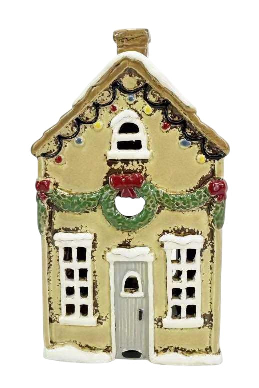 Decorative gingerbread house with a wreath on a white background