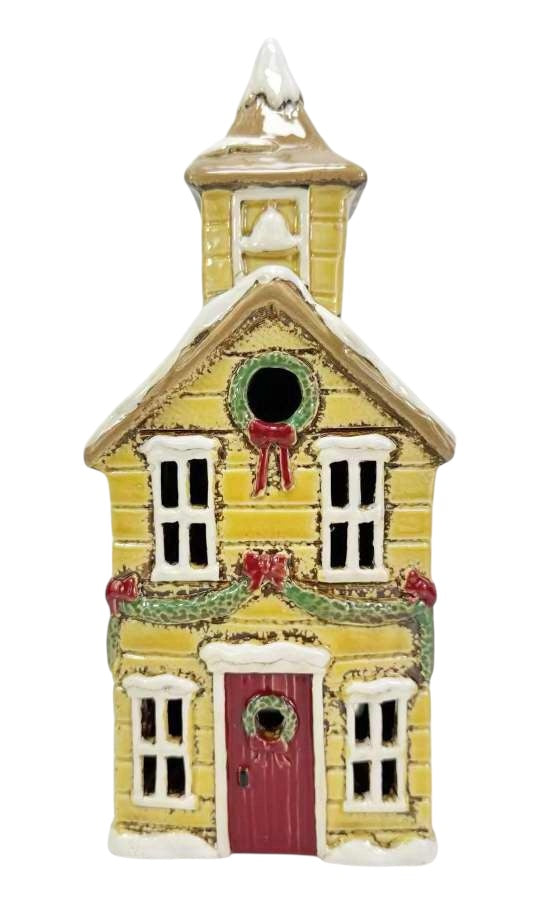 Decorative yellow house ornament with a red door on a white background