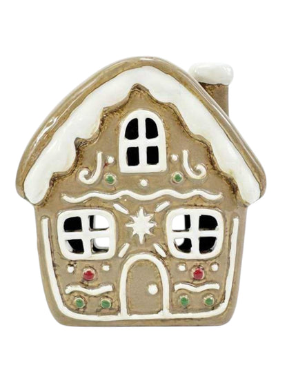 Decorative gingerbread house ornament on a white background