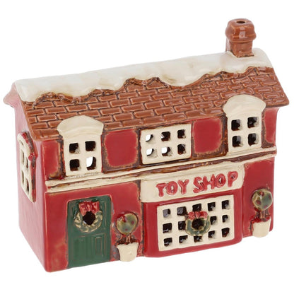 Small ceramic toy shop model with red facade and brown roof on a white background